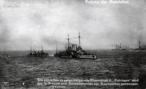 A re-enactment of the stand-off in the Schilling roads, shows SMS Thüringen threatened by two destroyers and a submarine. 